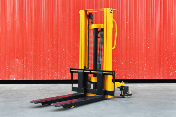 yellow electric forklift pallet stacker crane in the warehouse front
